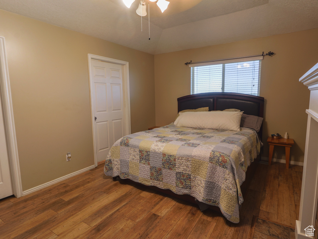 Bedroom featuring hardwood / wood-style flooring and baseboards