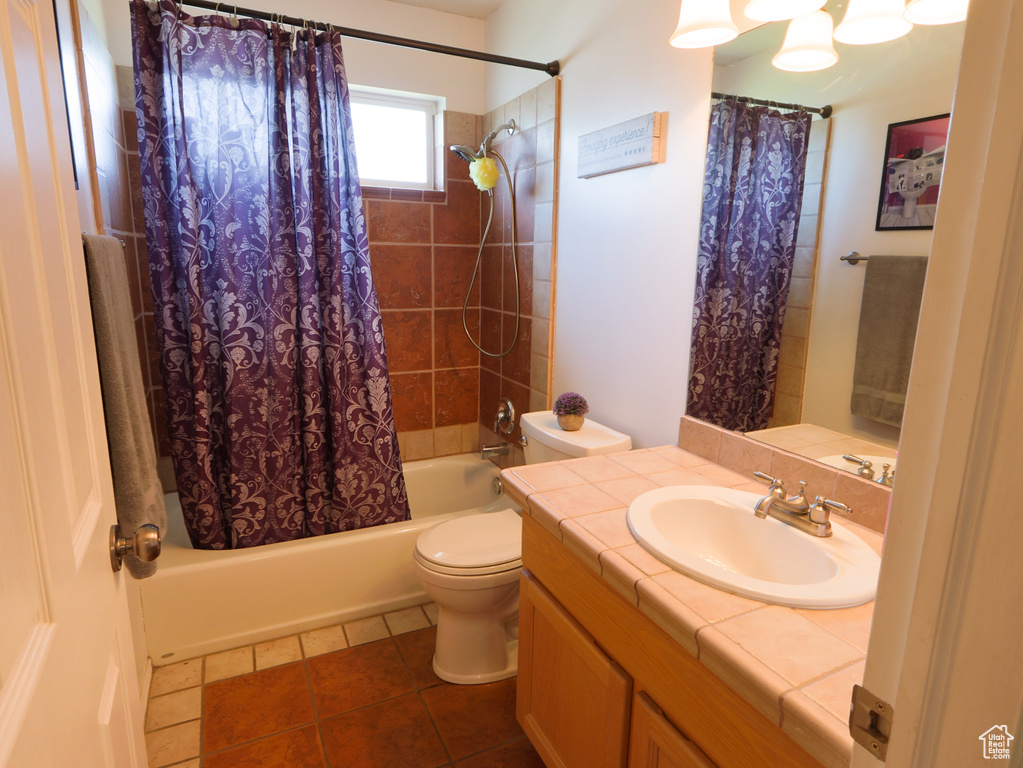 Bathroom with shower / bath combo, vanity, toilet, and tile patterned floors