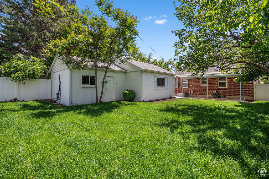 Rear view of property with a patio area and brick siding