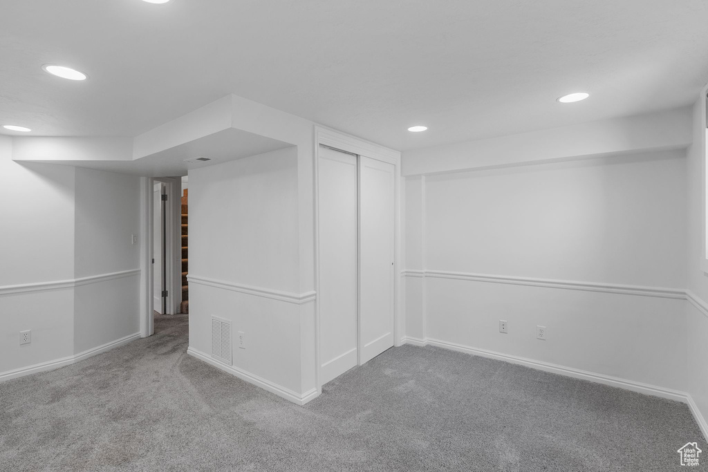 Finished basement with carpet, baseboards, and recessed lighting