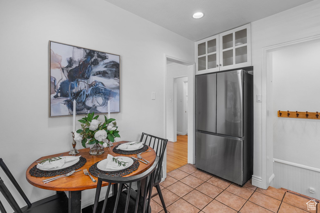 Dining area featuring light tile patterned flooring and recessed lighting