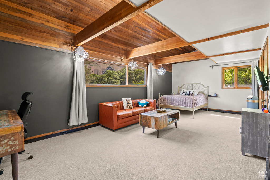 Bedroom featuring wooden ceiling with exposed beams, carpet, and baseboards