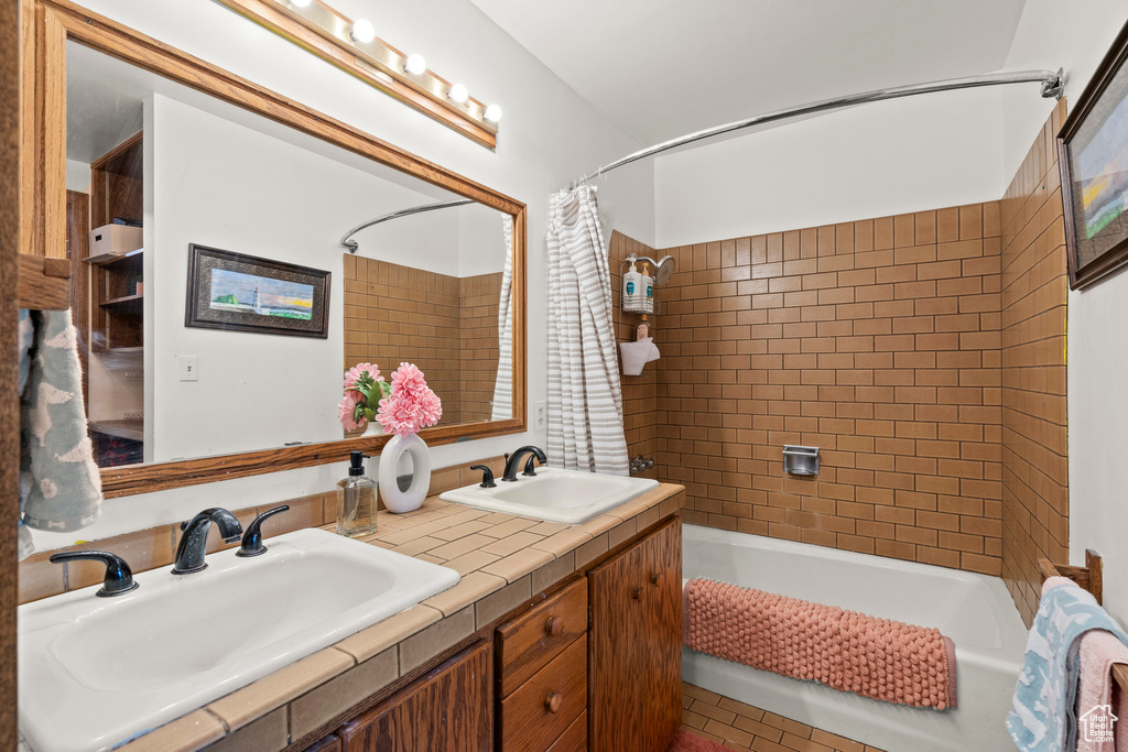Full bath with shower / tub combo and double vanity