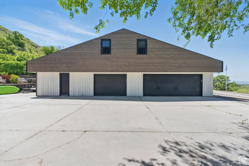 Garage featuring a garage and driveway