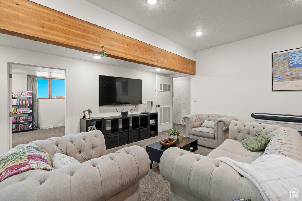 Carpeted living room with recessed lighting and baseboards