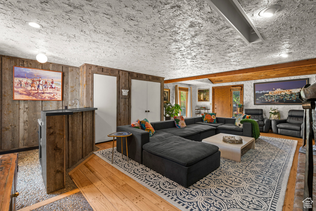 Living room with hardwood / wood-style flooring and wood walls
