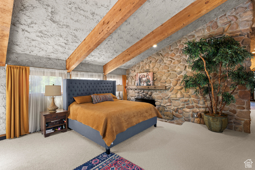 Bedroom featuring multiple windows and carpet flooring
