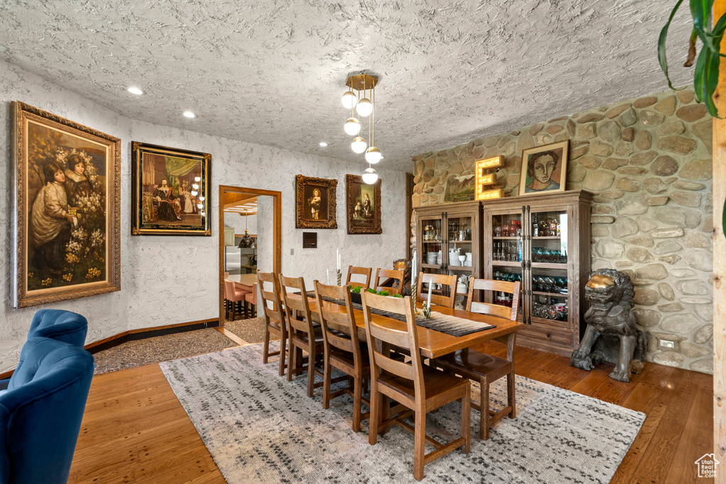 Dining space with wood-type flooring, baseboards, and recessed lighting