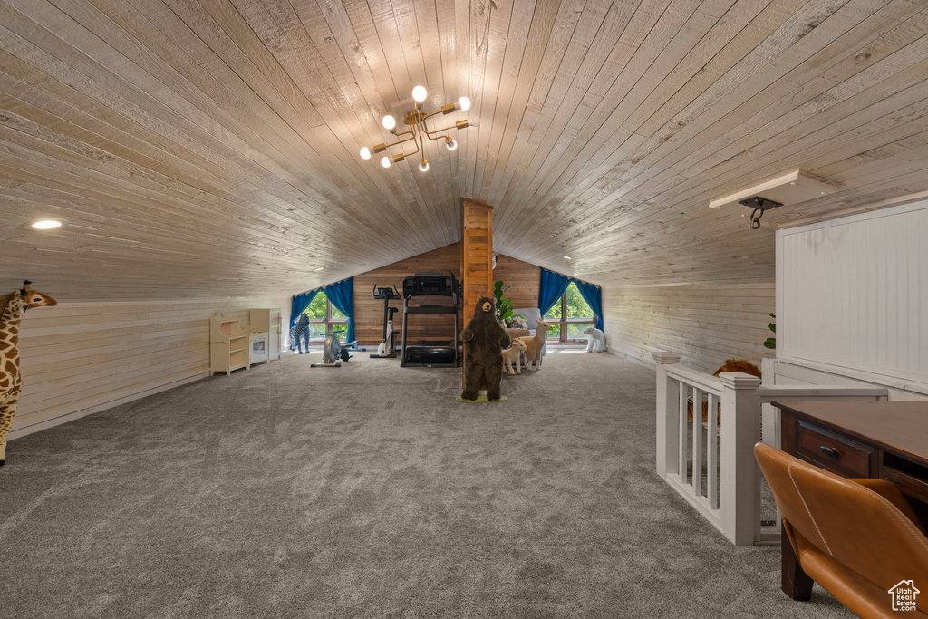Additional living space with wooden walls, wooden ceiling, vaulted ceiling, and carpet flooring