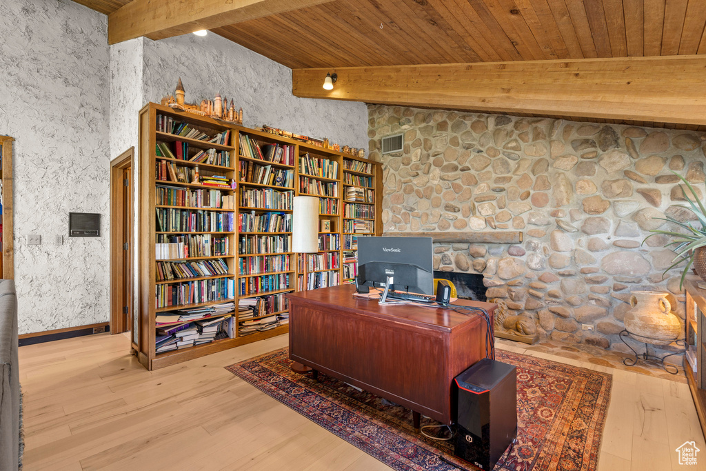 Office area with wooden ceiling with exposed beams and wood finished floors