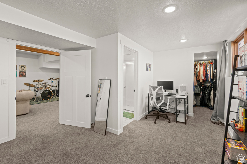 Home office with carpet floors, a textured ceiling, baseboards, and recessed lighting