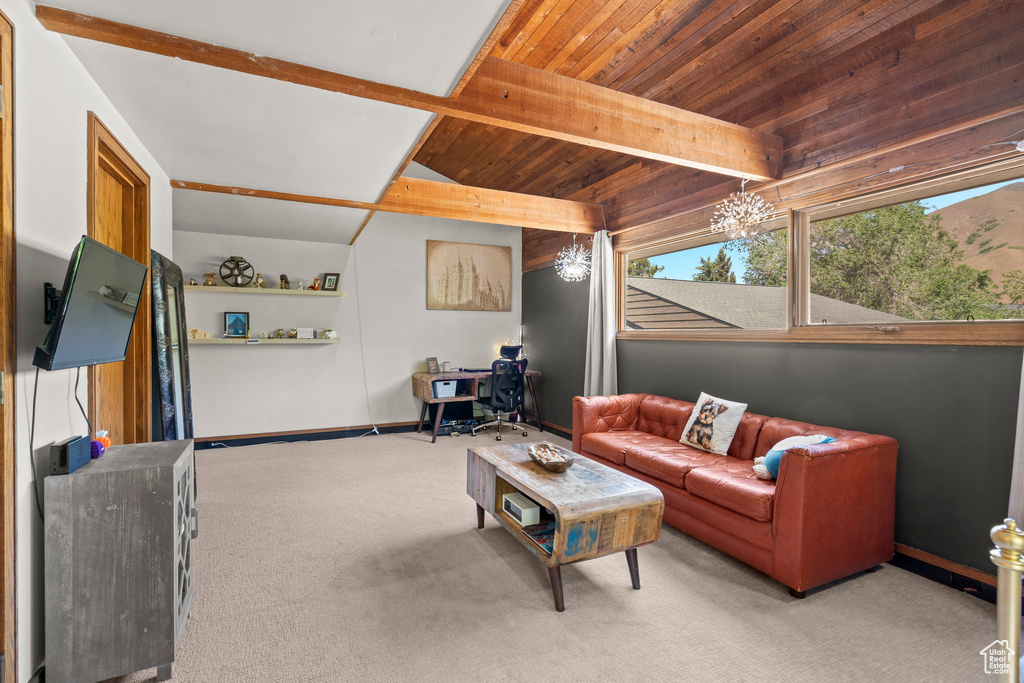 Carpeted living room with a chandelier, baseboards, and wood ceiling with exposed beams