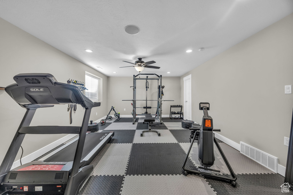 Exercise room with recessed lighting, a ceiling fan, and baseboards