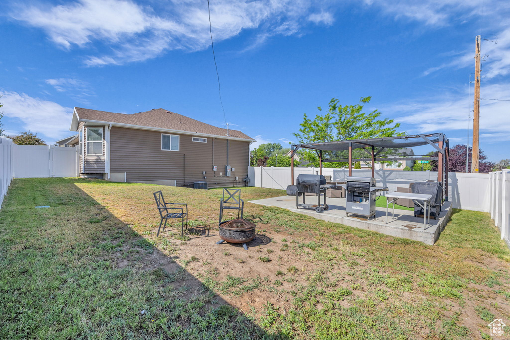 View of yard with an outdoor fire pit, a patio, and a pergola