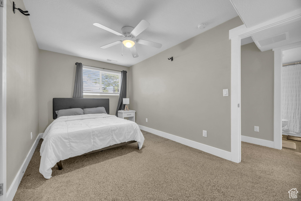 Bedroom featuring carpet floors, baseboards, and a ceiling fan