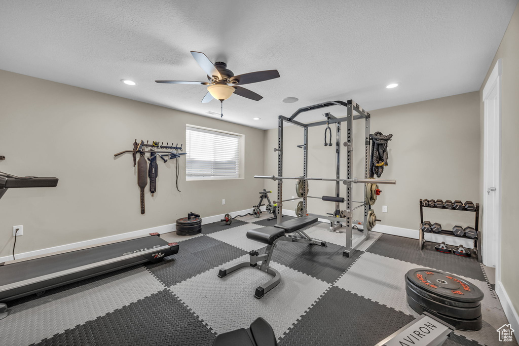 Workout room with a ceiling fan, baseboards, recessed lighting, and a textured ceiling