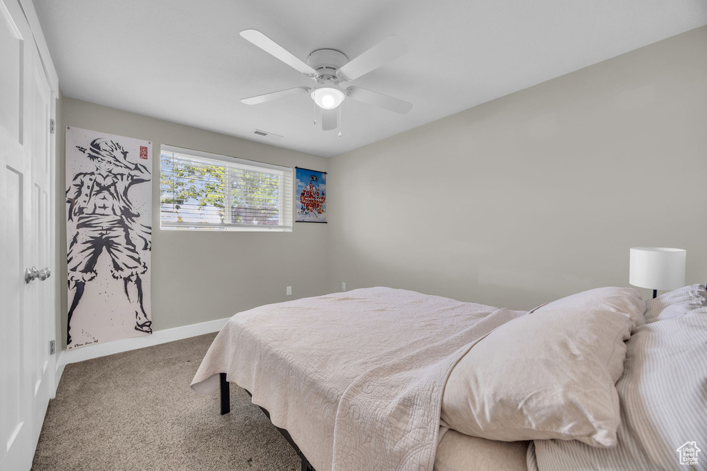 Bedroom with carpet floors, baseboards, and ceiling fan