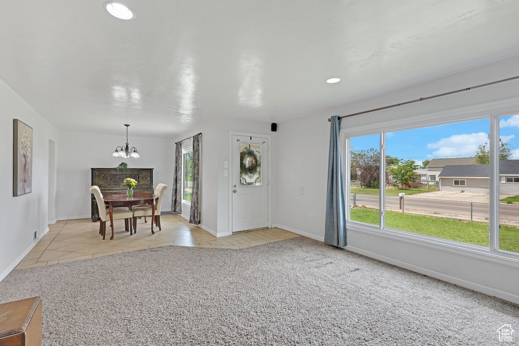 Dining room featuring a chandelier, plenty of natural light, baseboards, light tile patterned floors, and recessed lighting