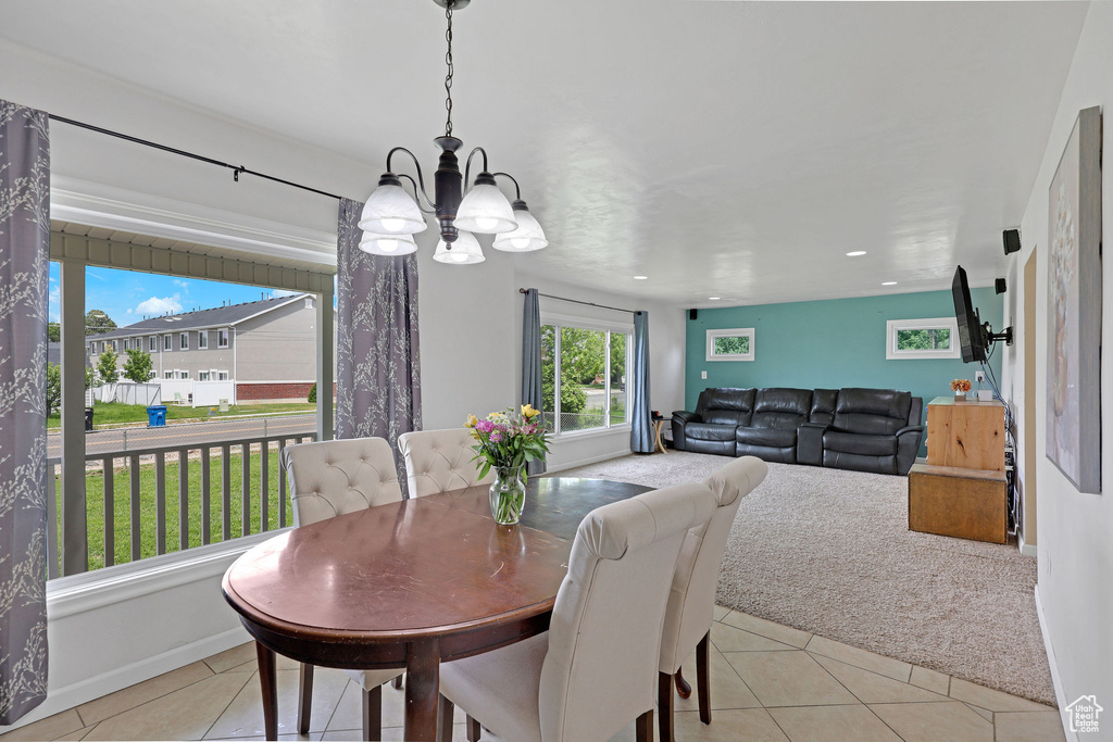 Dining area featuring a chandelier, light tile patterned flooring, recessed lighting, and baseboards