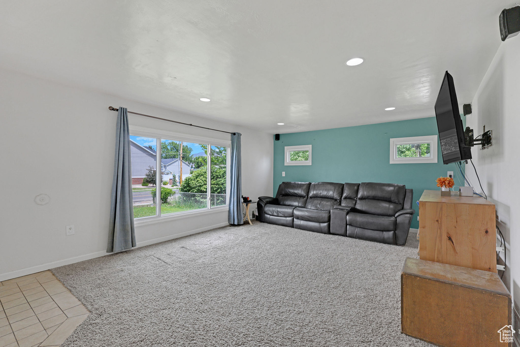 Carpeted living area featuring recessed lighting, tile patterned flooring, and baseboards
