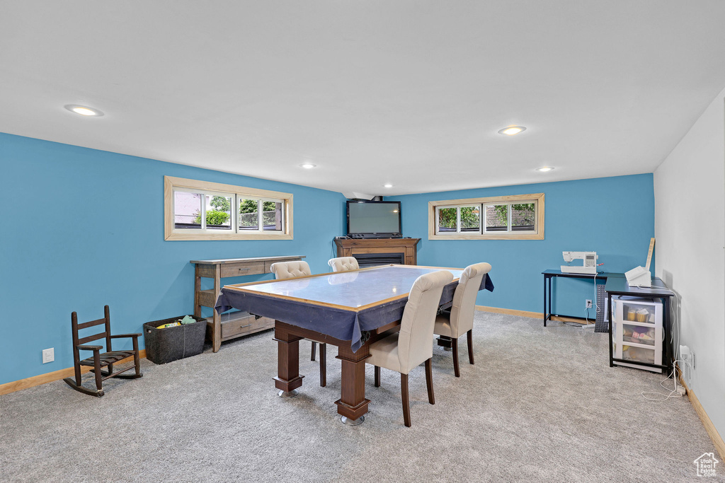 Dining room with light colored carpet, healthy amount of natural light, a fireplace, baseboards, and recessed lighting