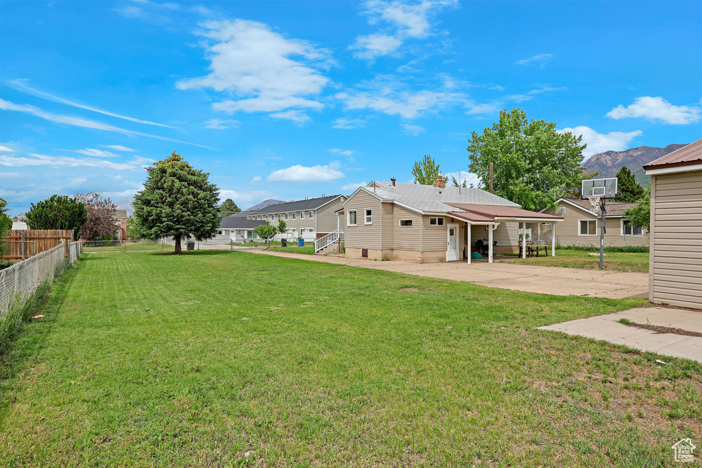 View of yard with concrete driveway