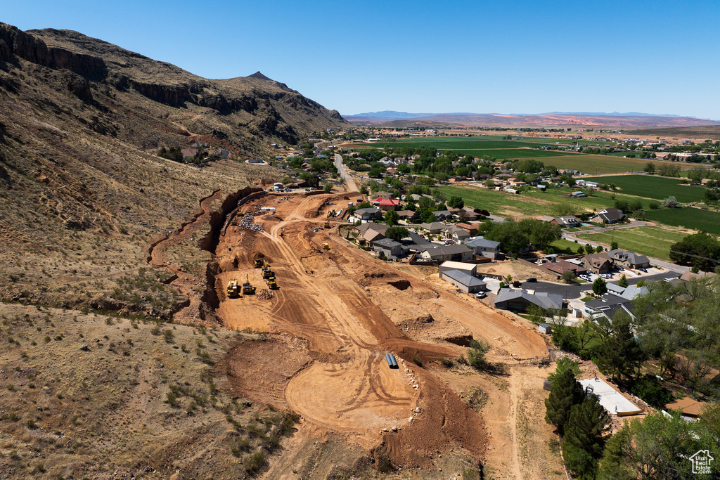 Aerial view of property and surrounding area with a mountain backdrop