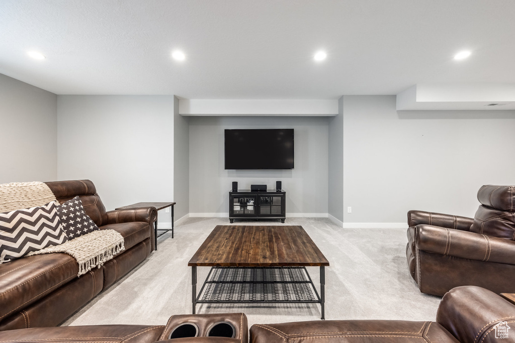 Living area featuring light carpet, recessed lighting, and baseboards