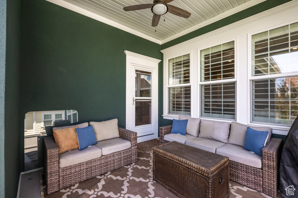 View of patio with an outdoor hangout area and a ceiling fan