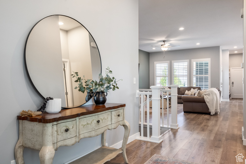 Hall featuring recessed lighting, wood finished floors, and baseboards