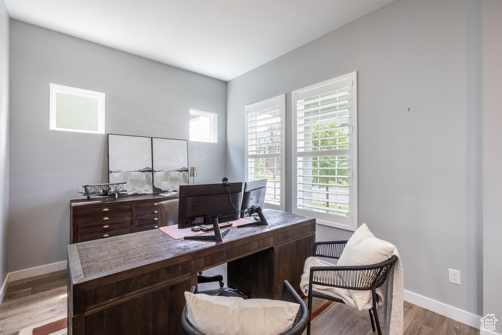Office space with baseboards and light wood-style floors