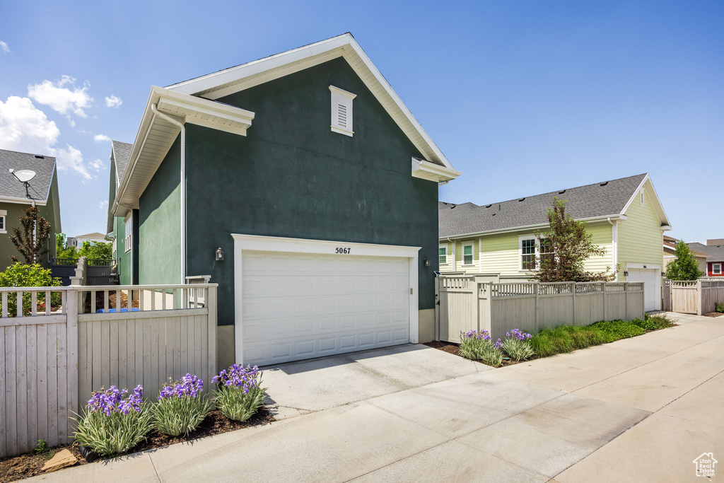 View of front of property featuring driveway and stucco siding