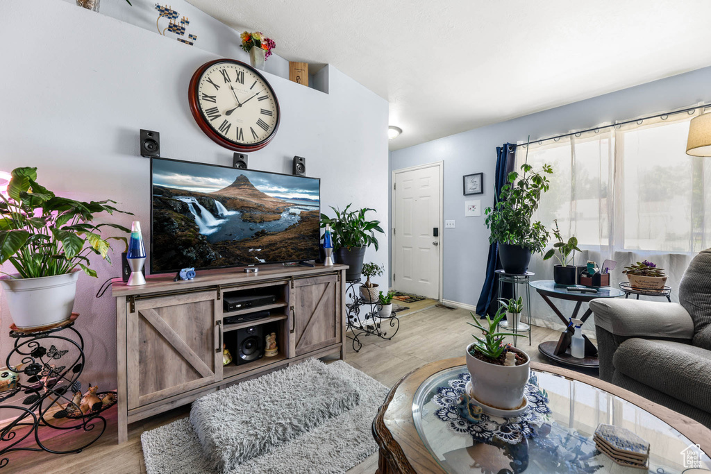 Living room with light wood-style floors and baseboards