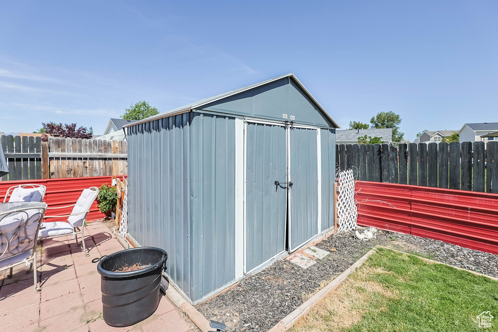 View of shed with a fenced backyard