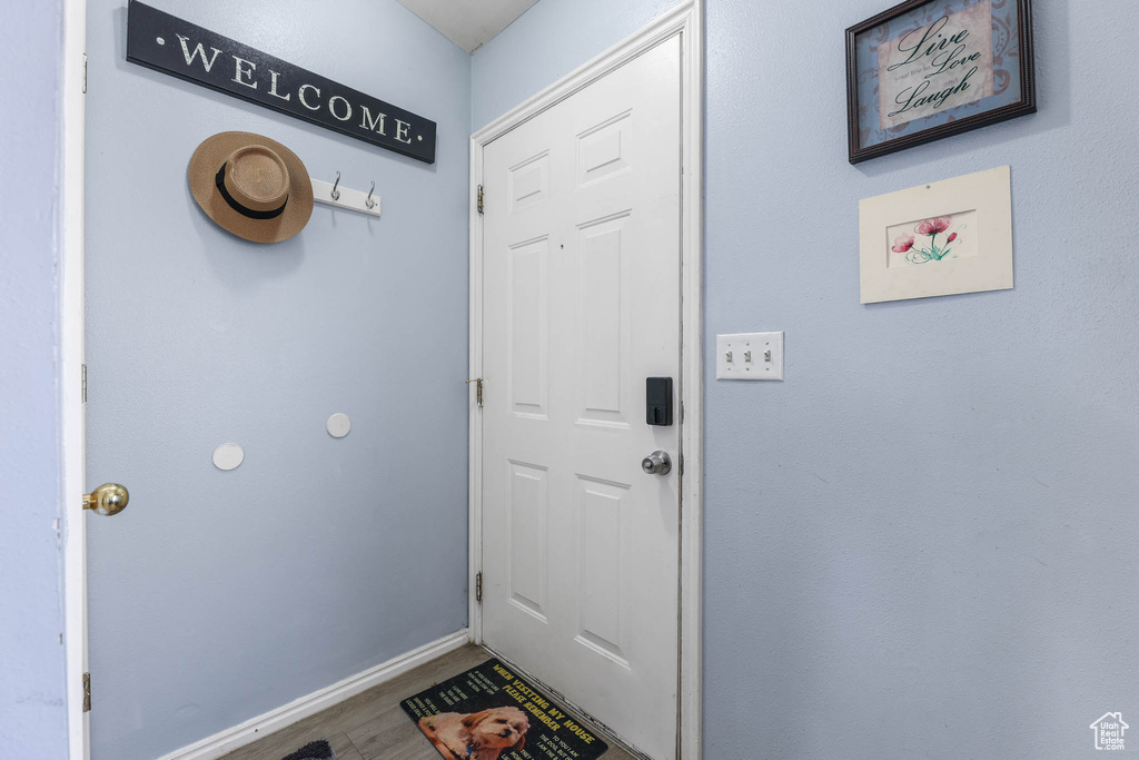 Entryway featuring wood finished floors and baseboards