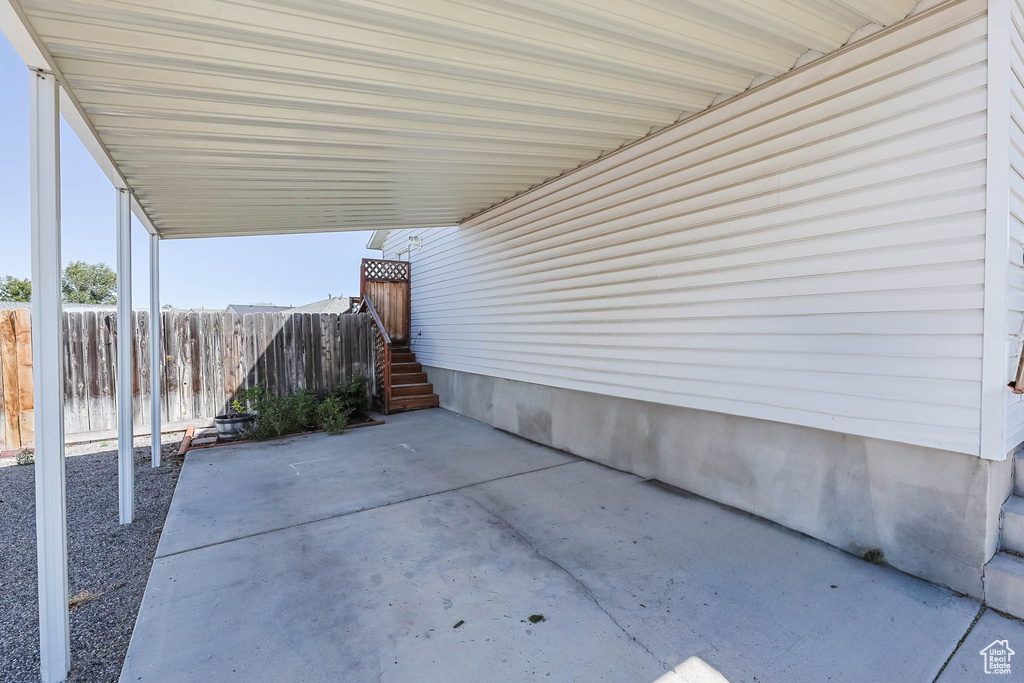 View of patio with a carport