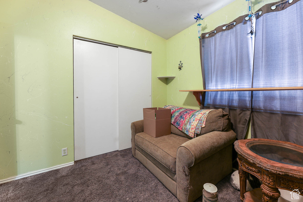Sitting room featuring vaulted ceiling and carpet floors
