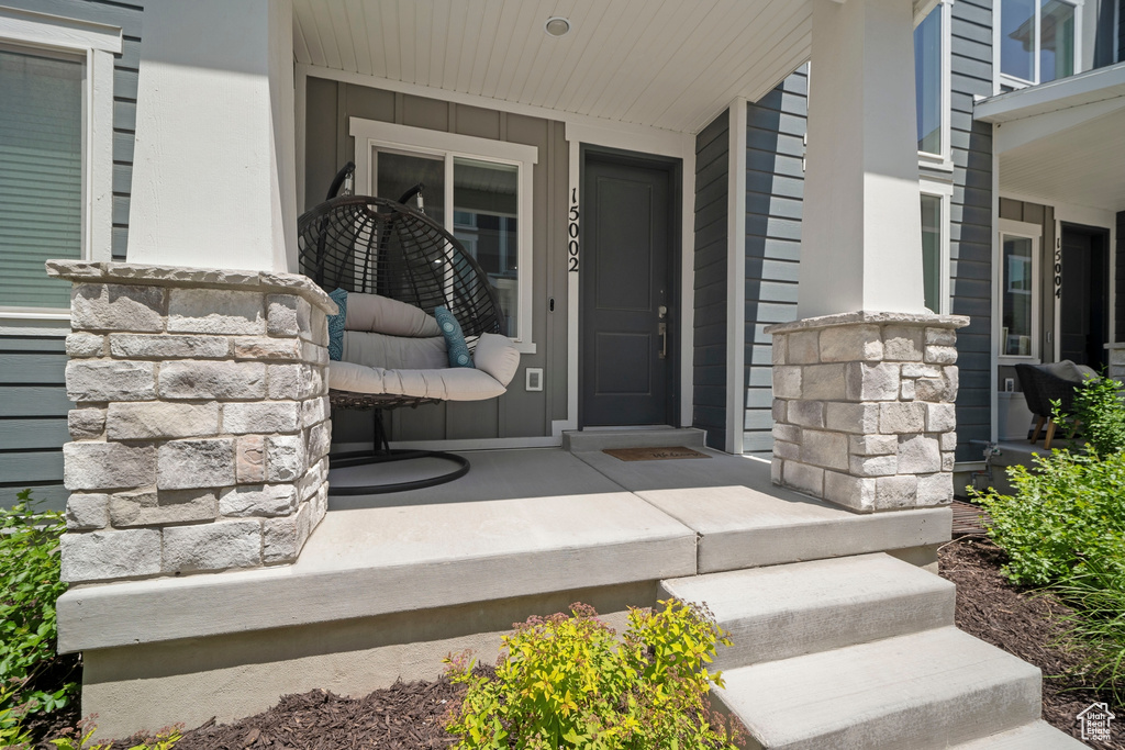 Doorway to property featuring a porch