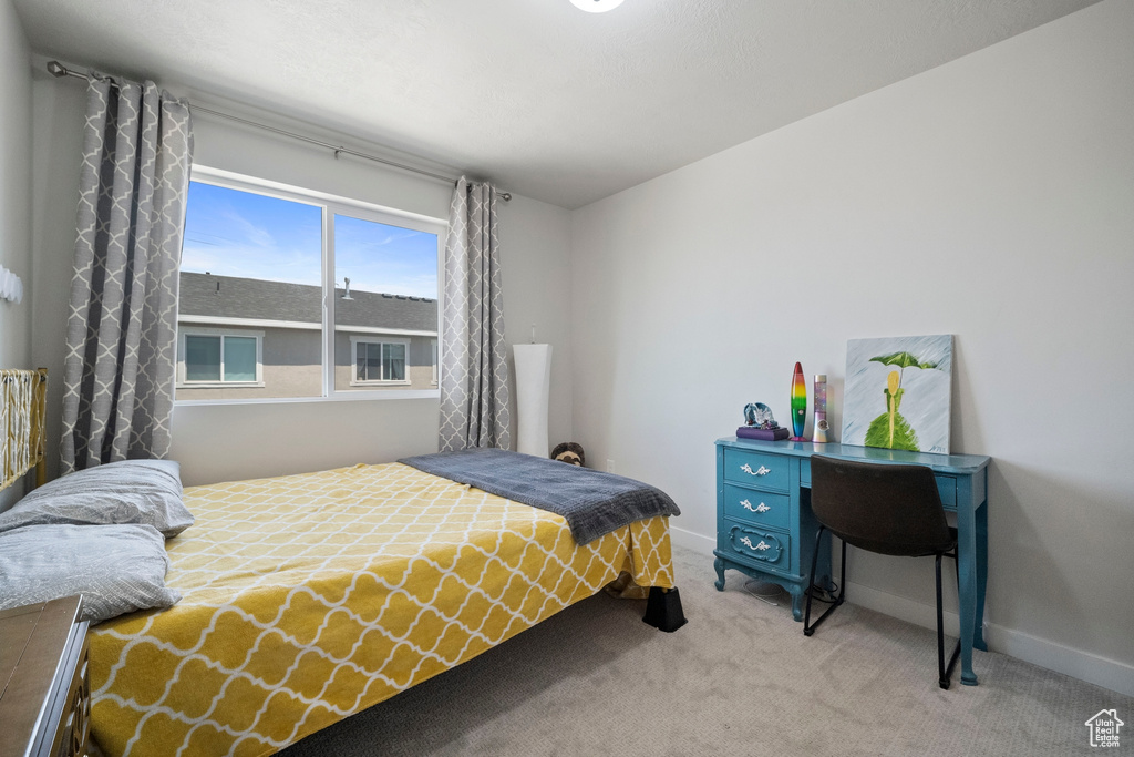 Bedroom with light carpet and baseboards