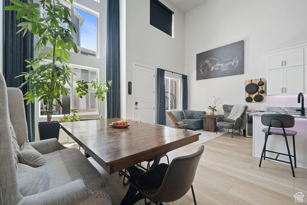 Dining area featuring a high ceiling and light wood-style flooring