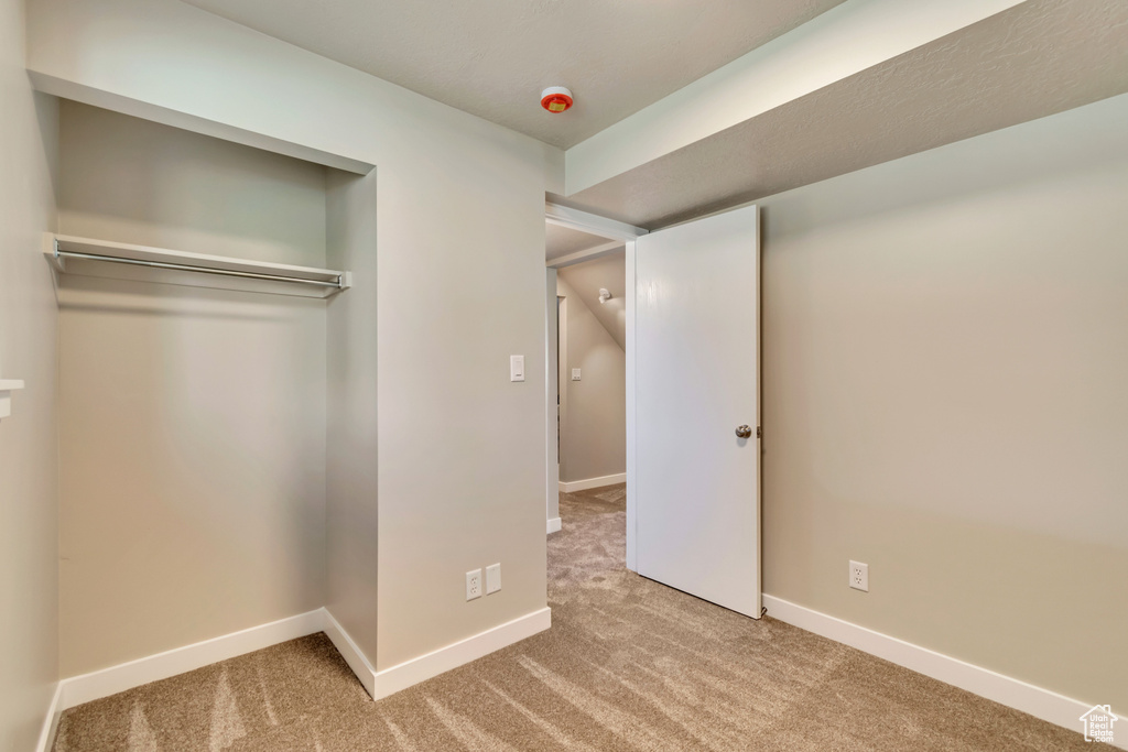 Unfurnished bedroom featuring carpet flooring and baseboards