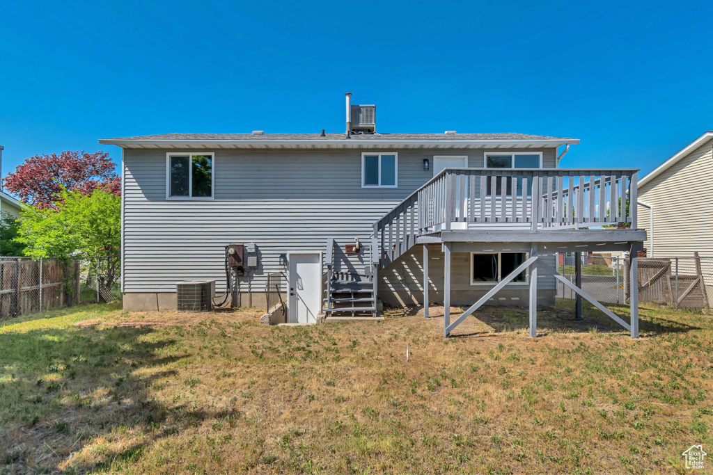 Rear view of house featuring stairs, a deck, and cooling unit