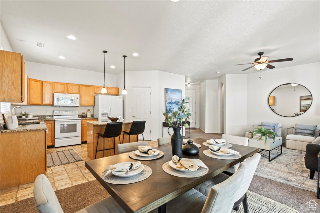 Dining room with a ceiling fan and recessed lighting