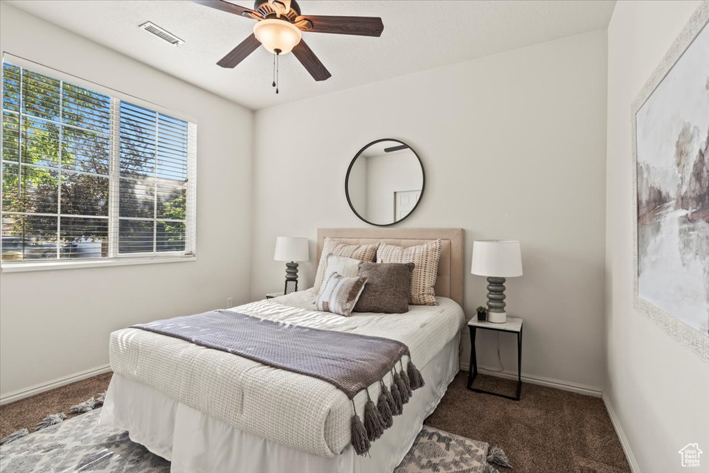Bedroom with carpet, baseboards, and a ceiling fan