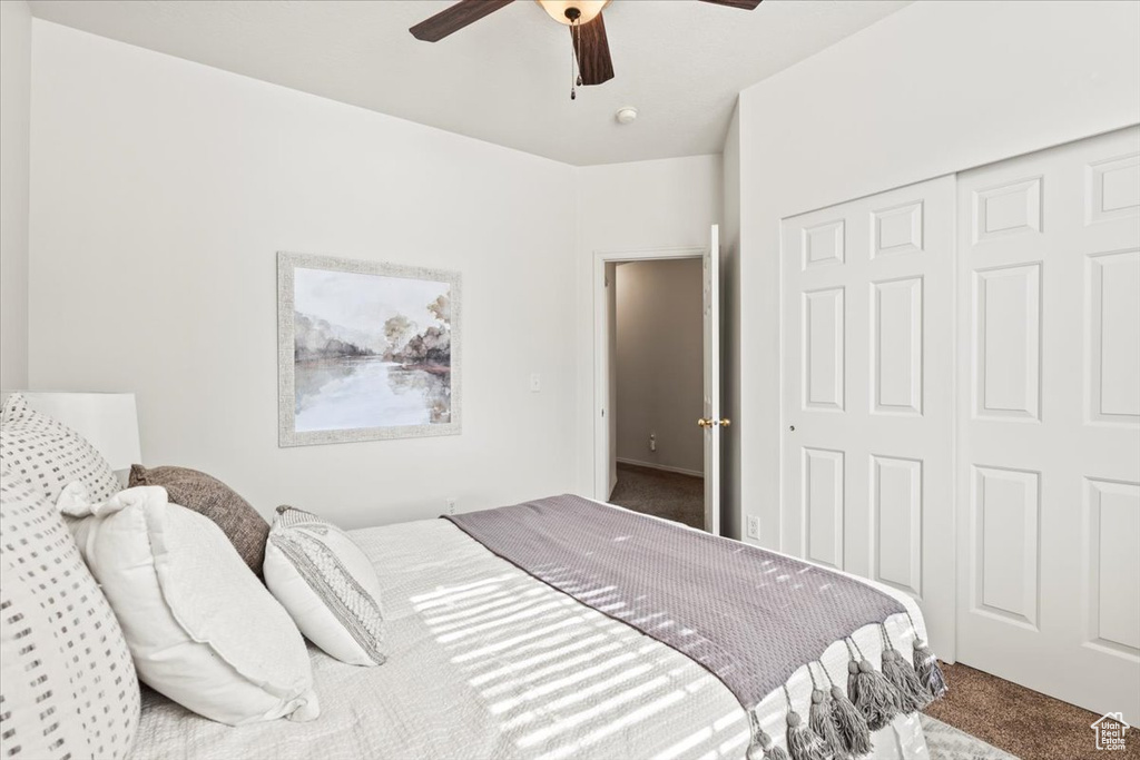 Bedroom featuring carpet flooring, a closet, and a ceiling fan