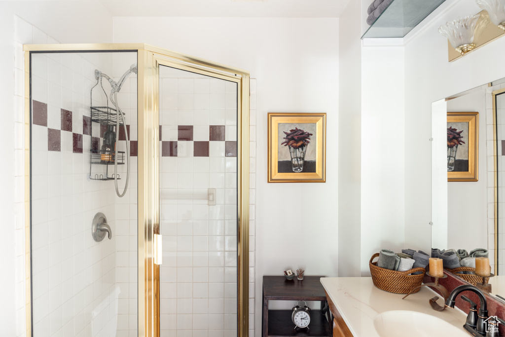 Full bathroom with vanity and a shower stall