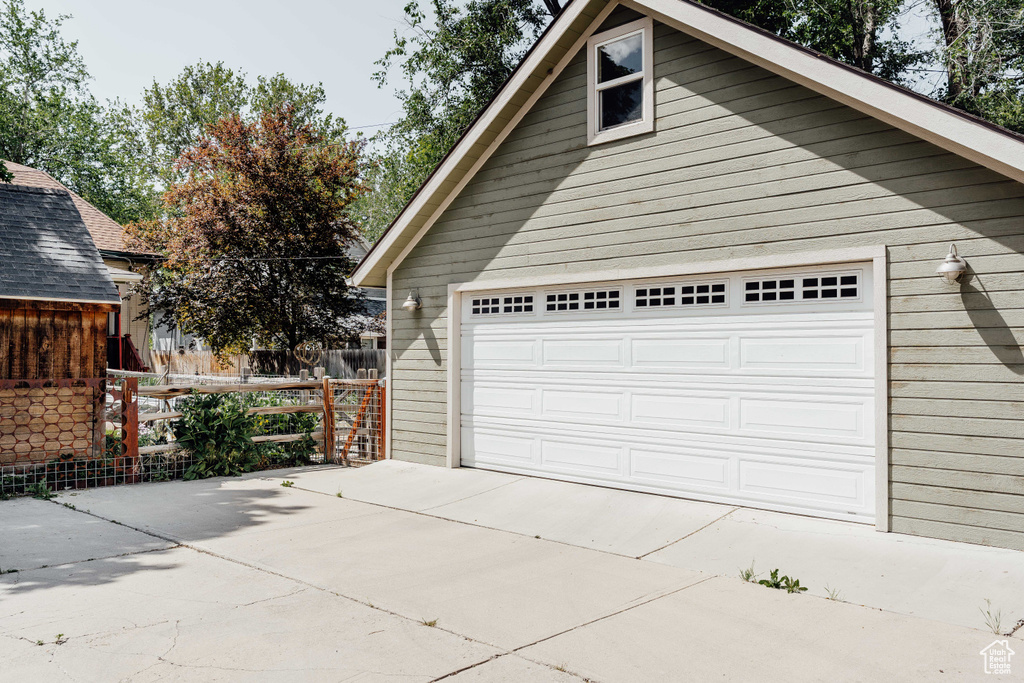 Garage featuring concrete driveway
