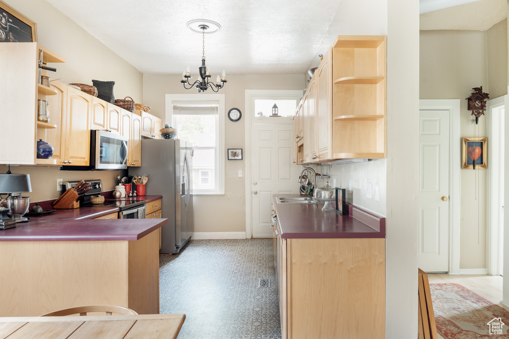 Kitchen featuring open shelves, stainless steel appliances, dark countertops, and baseboards