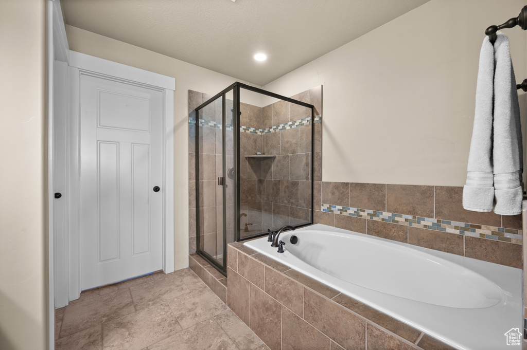 Bathroom with a garden tub and a stall shower