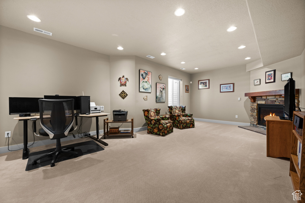Workout room with light carpet, baseboards, recessed lighting, and a fireplace